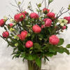 Medium high floral arrangement compose of an assortment of Coral charm peonies