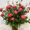 Medium high floral arrangement compose of an assortment of Coral charm peonies