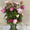 Peonies and green trick sweet William  arranged in a glass cylinder.