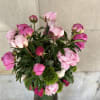 Peonies and green trick sweet William  arranged in a glass cylinder.