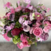 This elegant arrangement, complemented by swirling garden roses , soft and subtle