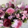 This elegant arrangement, complemented by swirling garden roses , soft and subtle