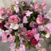This elegant arrangement, complemented by swirling garden roses , soft and subtle