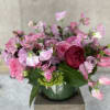 This elegant arrangement, complemented by swirling garden roses , soft and subtle