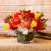Colorful cube arrangement that includes pin cushion protea, calla lilies, roses,
hydrangea, ranunculus