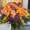 Bursting with color and life, this vivid casket spray is a joyful
