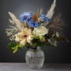 A simple and elegant budvase arrangement of white and blue florals. Touches