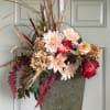 Fall front door arrangement in cute tin container with artificial flowers.