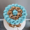 An opulent ring of shimmering gold roses encircles preserved aqua blooms, crowned