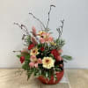 This warm and charming design is arranged in a red ceramic cardinal