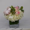 mix of roses hydrangeas and greens in  a nice square vase