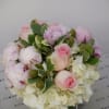 mix of roses hydrangeas and greens in  a nice square vase