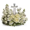 A keepsake crystal cross is framed by a collection of mixed all