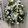 White lilies, carnations and roses on a green landscape with gray filler.