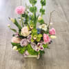 A vertical design with seasonal spring flowers in pastel mix Flowers may