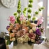 A vertical design with seasonal spring flowers in pastel mix Flowers may