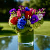 A treasure trove of vibrant blooms, the Jewel Box Arrangement is a