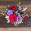 A Low Elegant Centerpiece of 5 open white roses, specialty lisianthus (or