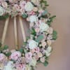 A standing 24 inch diameter Wreath on a wooden easel (included) with