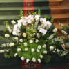 orchids and roses, green hydrangea larkspur and bells of Ireland  