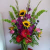 Deep purple gladiolas, red gerberas, sunflowers and a more making this arrangement