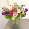 This is a vibrant and lush floral arrangement presented in a large