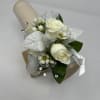   A corsage with a slap-on bracelet combines traditional elegance with