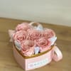 Preserved pink roses, placed in a pink gift heart box.