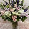 Tall cylinder vase,  with pink lilies, purple larkspur, white and pink