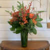 Sunflowers, orange roses, pale blue delphinium, magenta stock, orange snapdragons and orange