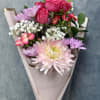 Our petite Pink Breeze hand-tied bouquet features cheerful mums, spray roses, daisies