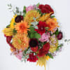Spiked Cider features Sunflowers, Burgundy Ranunculus, Deep Purple Roses, Burgundy Button Mums