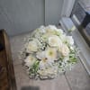 A timeless display of grace and sophistication, this all-white floral arrangement exudes