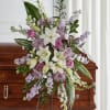 Lavender and white flowers beautifully arranged on this easel piece, ensure your