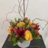 A beautiful compact design of asiatic lilies, roses, hypericum, eryngium and more