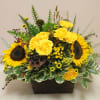 in a wooden box sit sunflowers and other rustic flowers 