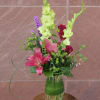 A springy arrangement of lilies, gladiolus, and hypericum.
