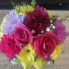 fresh colorful flowers in green polkadot green vase 