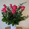 A timeless classic, send a dozen roses in a vase with complementing