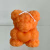 A handmade teddy bear candle crafted from delicate rose-shaped wax details. Perfect