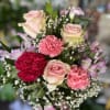 Fresh flowers in pink glossy vase 