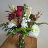  This rich mix of lilies, roses and lovely blossoms, simply arranged