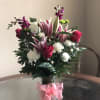  This rich mix of lilies, roses and lovely blossoms, simply arranged