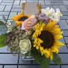 Dimension: 9.5&rdquo;H x 10&rdquo;W
Flowers: Roses ,Sunflowers, Alstroemerias , Fancy Carnations and other