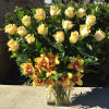 A spectacular arrangement of butter yellow roses rising up from a base