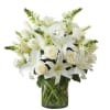 All-around arrangement with white roses, lilies and snapdragons; accented with greenery Artistically
