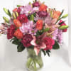 Orange Roses, Lavender moms Chrysanthemums, Purple Daisies, Pink Lilies, Hot pink carnations