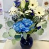 Blue Hydrangea, White lilies, Cream Gerberas daisies, Blue Delphinium, White Chrysanthemums and