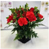 Red Carnation and Roses, Red Alstroemerias, Bupleurum, and Green seasonal foliage, Red