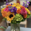 Hot pink, Yellow and Orange roses, Sunflowers, Purple Stock, Green Hydrangea, greens